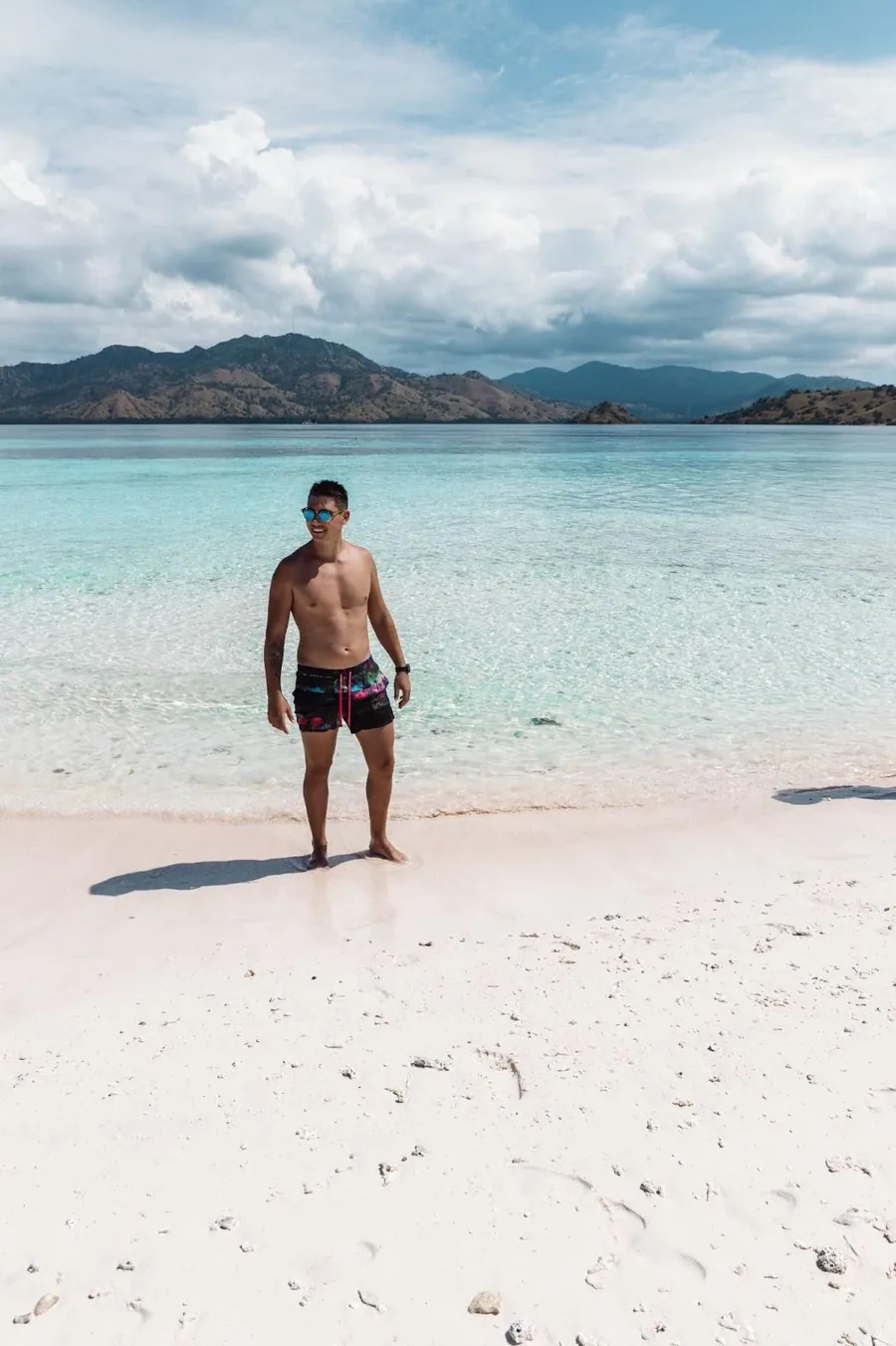Luke on a white sand beach